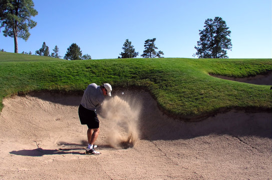golfer hitting out of a sand trap (2 of 3 shot act