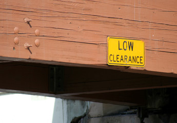 low clearance sign and bridge - obrazy, fototapety, plakaty