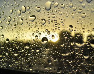 rain drops on the window, sunset in background, st