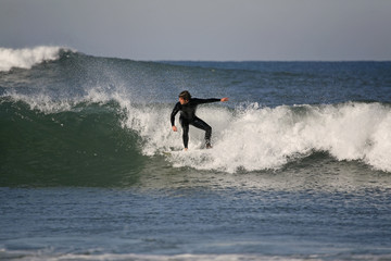 surfer rides a wave