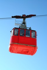 red funicular against a blue sky