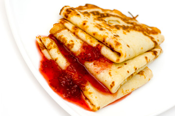pancakes with strawberry jam on a plate