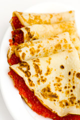 pancakes with red caviar on a plate