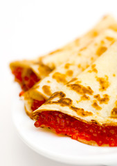 pancakes with red caviar on a plate