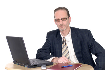 pensive looking businessman working on laptop