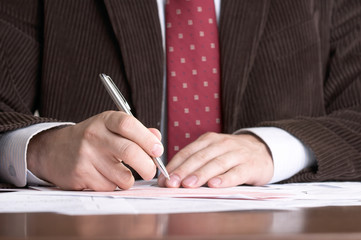 businessman signs documents