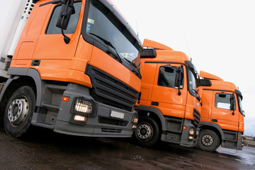 three orange lorries