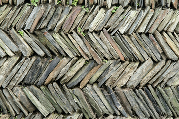 stacked slate stone wall.
