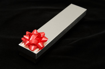 silver gift box on black velvet