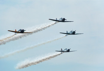 formation of four vintage airplanes