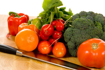 fresh vegetables on cutting board with knife