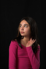 teen posing over black backdrop
