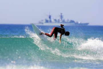 a surfer executing a backhand re entry