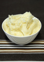 mashed potato in bowl with truffle oil tea towel