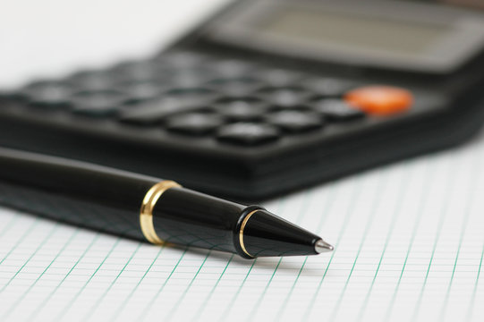 pen and calculator with shallow depth of field