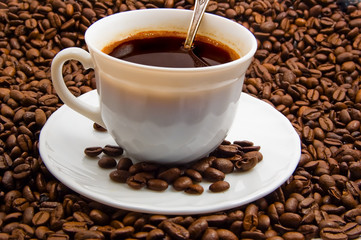 cap of coffee with cofee beans