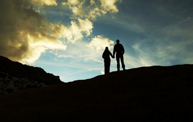 boy and girl silhouette on sunset