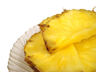 pieces of pineapple in a dish over white background