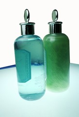 illuminated bottles of bath oils over white