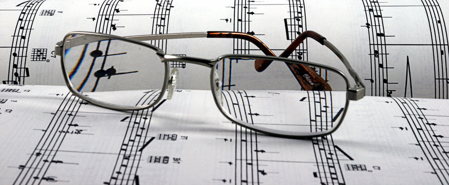 reading glasses on sheet music horizontal