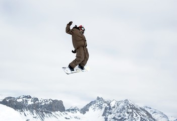 Fototapeta na wymiar snowboarder jumping high in the air