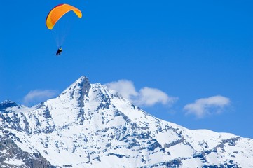 glider above snowed peak