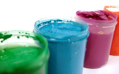 many opened paint jars with gouache