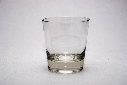 empty whiskey glass on white background