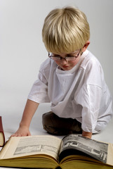 young boy is reading books