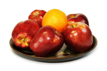 some red apples and an orange.