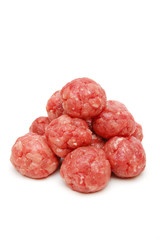 pyramid of raw meat-balls on white