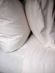 pair of white pillows and sheets