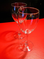 pair of wine glasses over  red and black