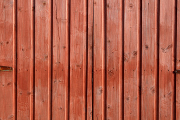 wooden orange/red stained fence background.