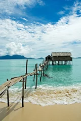 Fotobehang stilt house in tropical waters © javarman