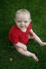 cute little boy sitting outside