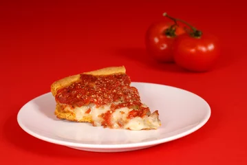 Foto op Plexiglas a piece of deep dish pizza with tomatoes © David Smith