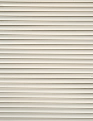 white shutters over a shop window.
