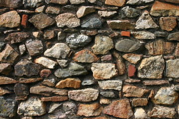 old stone wall with different colored stones