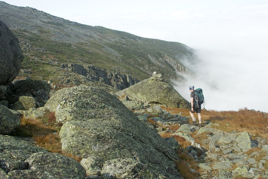 hiker above clouds