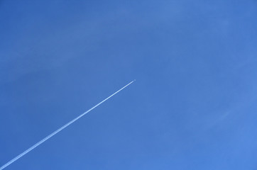 jet airplane going up in the blue sky
