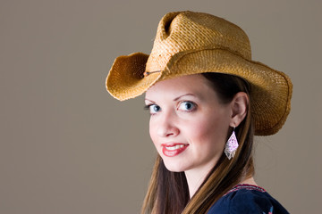 smiling brunette young woman in western hat