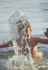 the boy bathes in water.