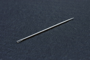 sewing needle on blac