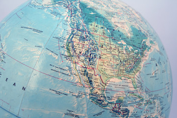 closeup of world globe focused on north america with blue backgr