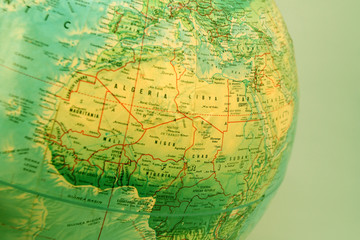 closeup of world globe focused on africa with green filter