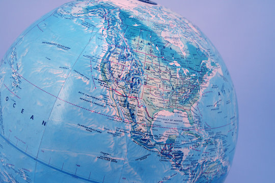 closeup of world globe with blue background