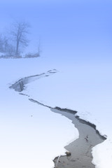 stream flowing on the frozen lake
