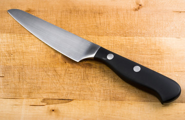stainless steel knife on wooden cutting board