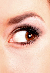 closeup of beautiful blonde female hazel colored eye looking to